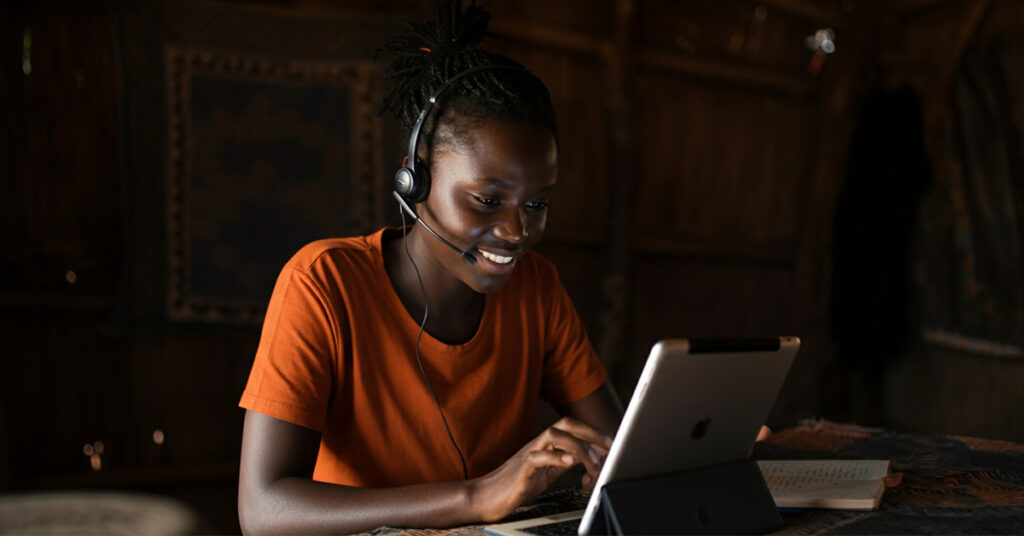 Nigerian student using tablet in remote area enabled by student journey automation in Nigeria