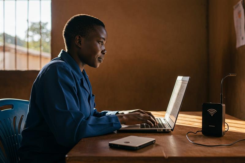 tudent in Africa accessing education through a student information system on a laptop.
