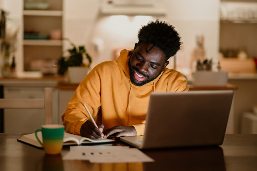 Student studying from home on laptop through affordable online courses
