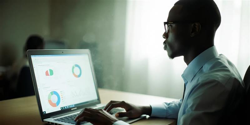 University IT admin at a desk, laptop displaying connected Learning Management System and CRM dashboards, digital lines connecting student data, assignments, and admission info, futuristic and professional environment, realistic style.